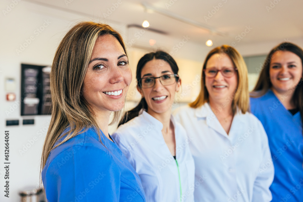 Cheerful women in medical uniform staring at camera Cheerful women in medical uniform staring at camera