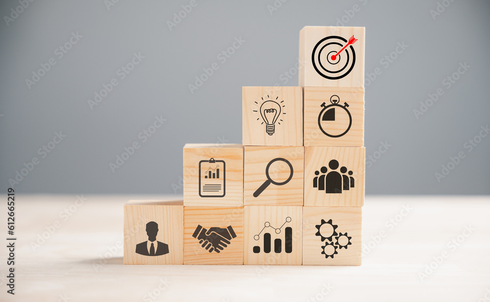 Wooden block cude step on a table with Action Plan, Goal, and Target icons. Success and business target concept. Project management and company strategy for financial growth. Wooden block cude step on a table with Action Plan, Goal, and Target icons. Success and business target concept. Project management and company strategy for financial growth.