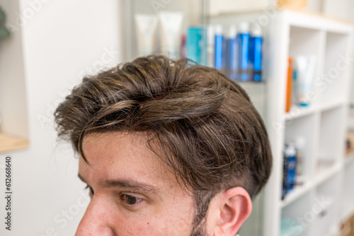bald man with wig being styled in beauty salon