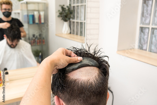 bald man with a wigbald man changing his hair prosthesis wig in esthet