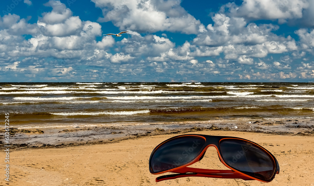 Sunglasses on the beach of the Baltic Sea, concept of bliss vacation