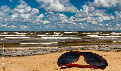 Sunglasses on the beach of the Baltic Sea, concept of bliss vacation