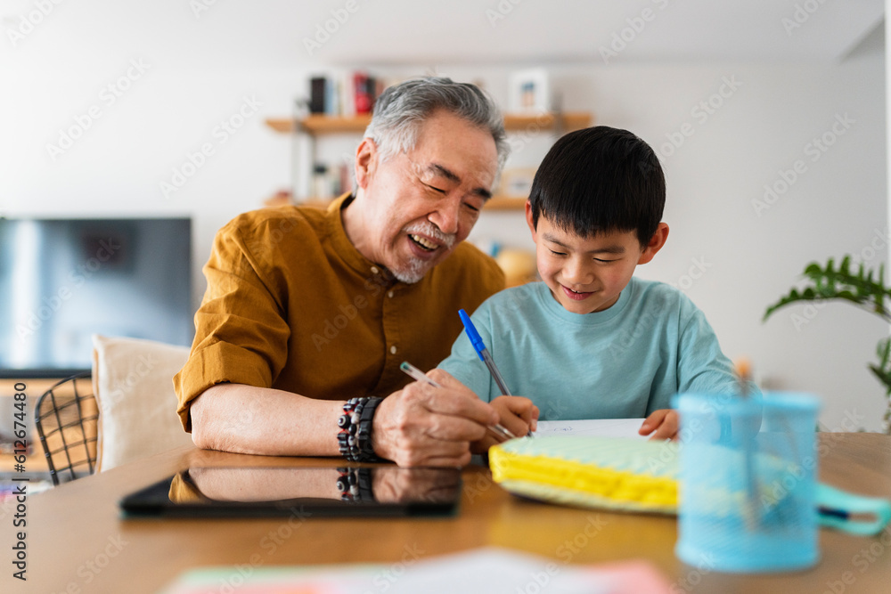 Elderly Chinese man helps grandson learn. Elderly Chinese man helps grandson learn.