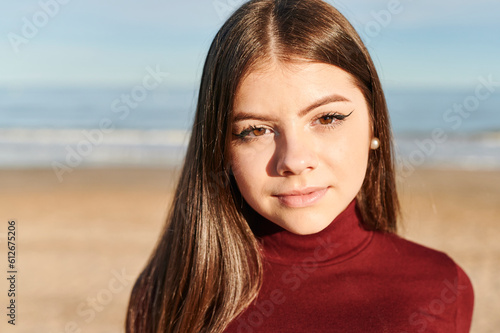 Teen standing on a sandy beach photo