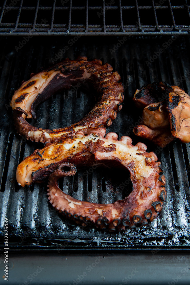 Octopus legs cooking on a barbeque Octopus legs cooking on a barbeque