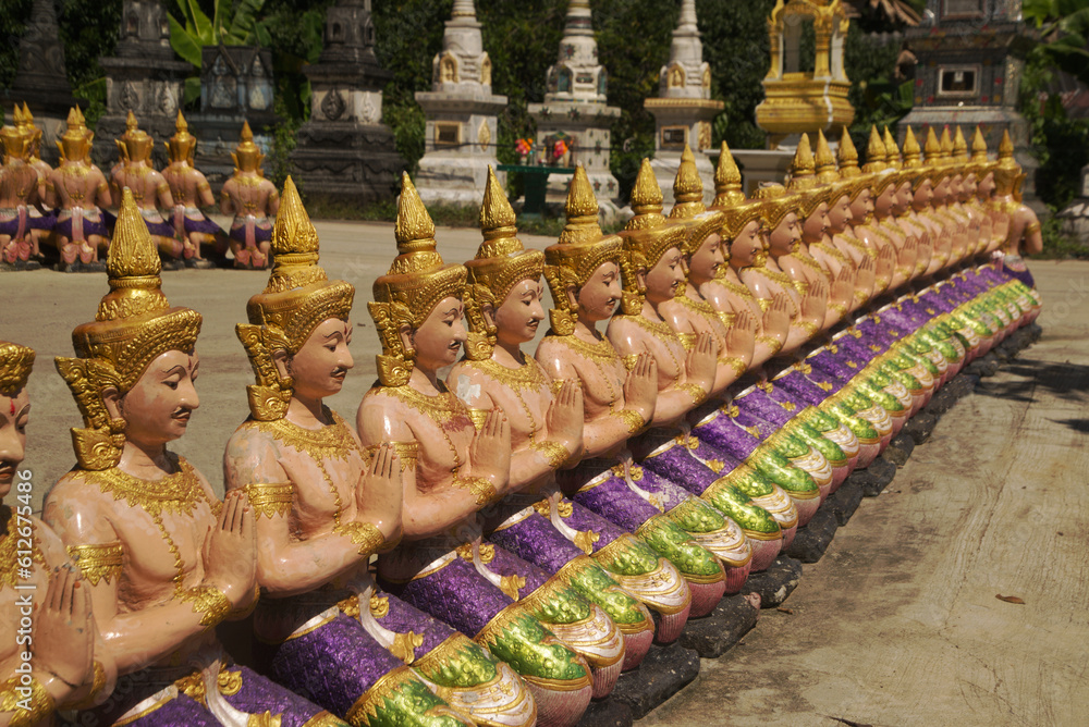 Fototapeta premium Statues of angels lined up in rows, beautiful, guarding and decorating the place at Wat Maneewong Temple. This is a travel to pay homage for sacred thing.
