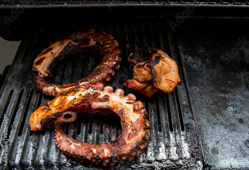 Octopus legs cooking on a barbeque photo
