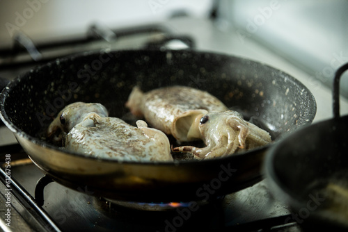 Cuttlefish cooking in a pan photo