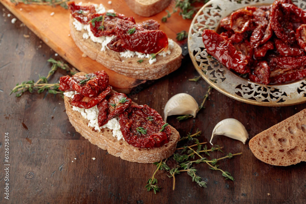 Bruschetta with ricotta, sun-dried tomatoes, and thyme.