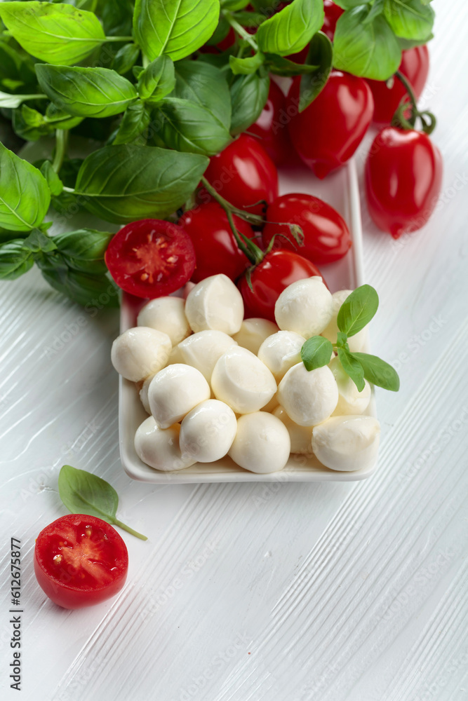 Mozzarella cheese with basil and tomatoes. Mozzarella cheese with basil and tomatoes.