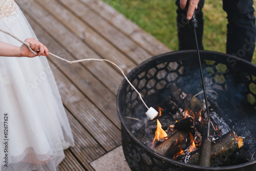 Family roasting a marshmallow on fire photo