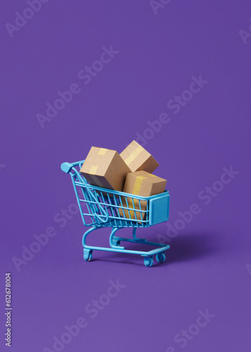 Many shopping bags in a shopping cart for online shopping concept photo