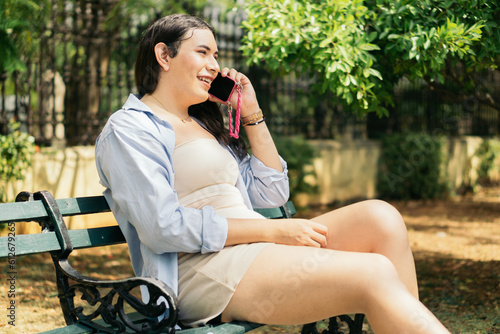 Transsexual woman sitting talking on the phone. photo