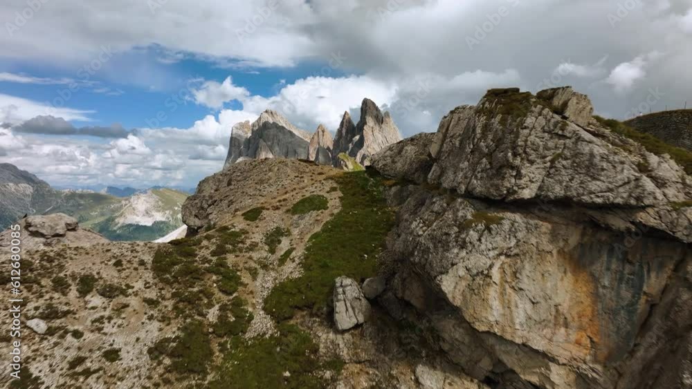 Aerial view over cliffs, revealing the Seceda ridge, summer day in Dolomites, Italy Aerial view over cliffs, revealing the Seceda ridge, summer day in Dolomites, Italy