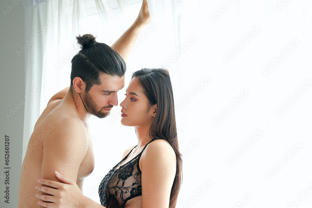 Φωτογραφία Caucasian adult man look at Asian pretty woman eyes with romance feeling near wh