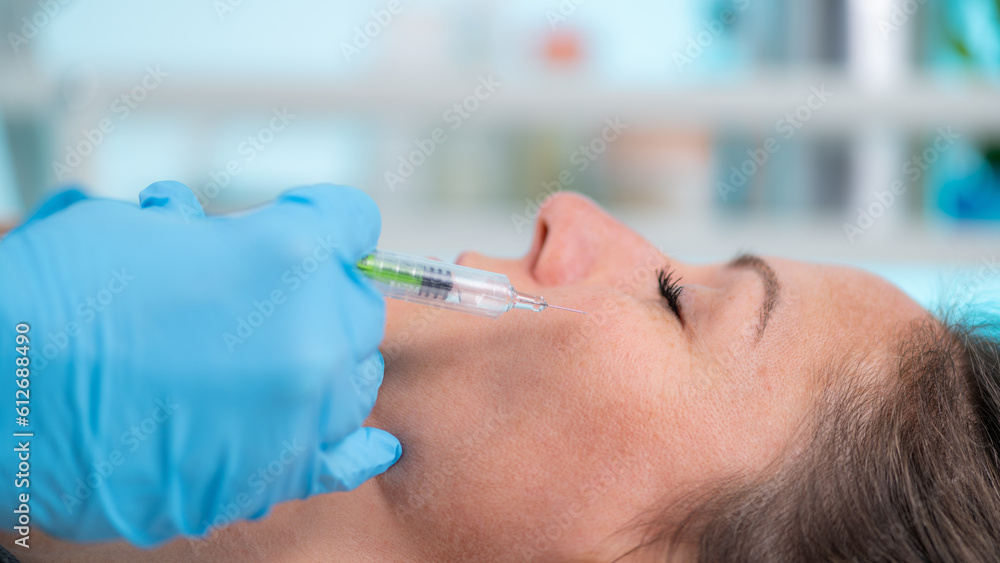 Hyaluronic acid treatment. Dermatologist plumping up cheeks with hyaluronic acid injection filler Hyaluronic acid treatment. Dermatologist plumping up cheeks with hyaluronic acid injection filler