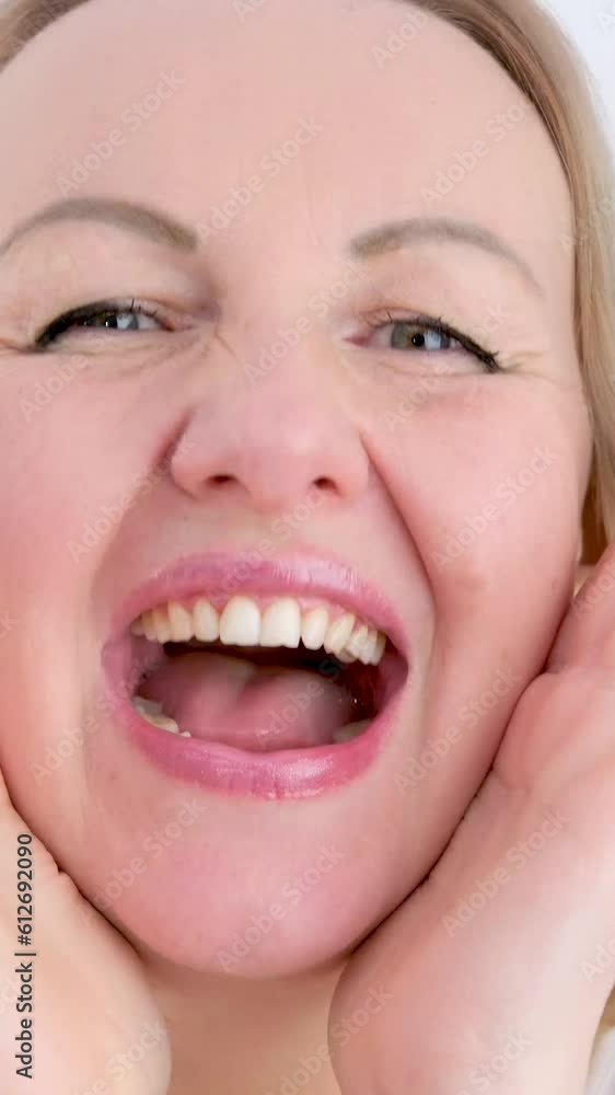 different cheerful positive emotions of a girl woman put 2 hands to her face opened her mouth laughing eyes smiling beautiful straight teeth different cheerful positive emotions of a girl woman put 2 hands to her face opened her mouth laughing eyes smiling beautiful straight teeth