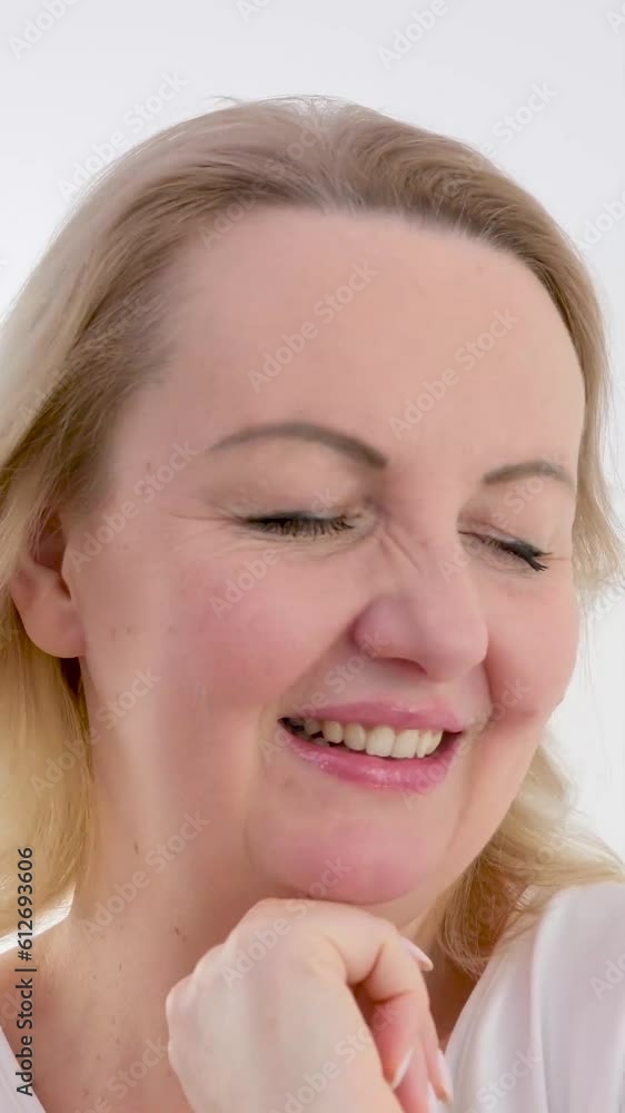 Happy 40s middle aged mature woman touching facial skin looking at camera pampering in mirror Old healthy dry skin care beauty concept skincare treatment, cosmetics and anti age plastic surgery Happy 40s middle aged mature woman touching facial skin looking at camera pampering in mirror Old healthy dry skin care beauty concept skincare treatment, cosmetics and anti age plastic surgery