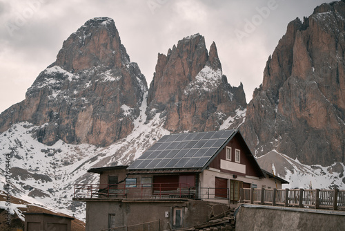 Solar panels on the roof. Concept of using photovoltaics in rural areas and countryside for a sustainable future. Modern house with an alternative source of electrical energy.