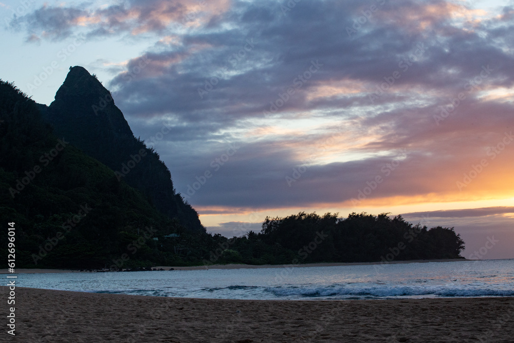 Sunset on Sandy Beach in Front of Headland in Kauai Hawaii