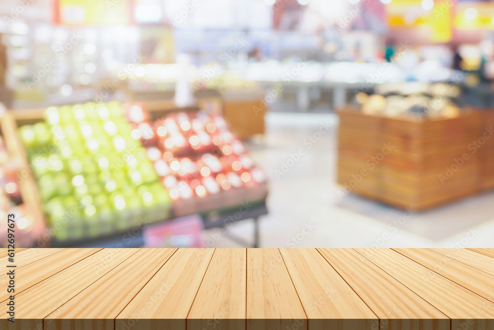 Empty wood table top with supermarket blurred background for product display