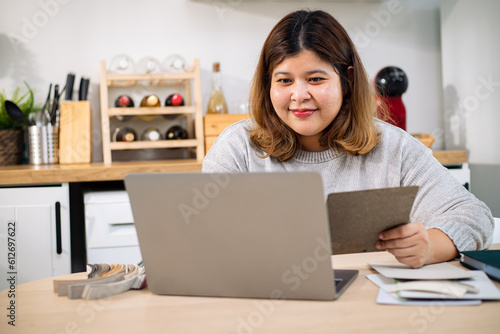 Stylish brown haired chubby student girl in eyewear learning online, has to stay home. Chubby young woman working on laptop