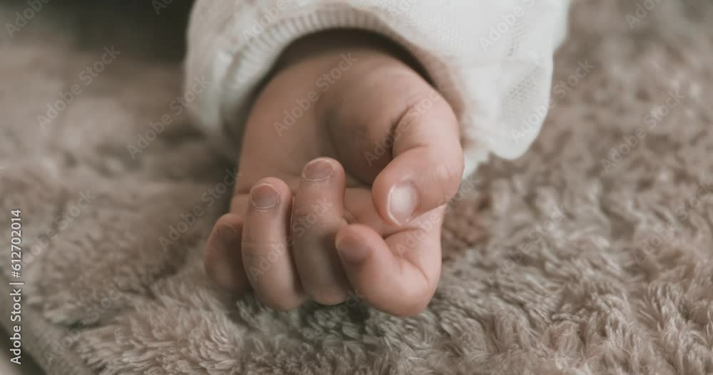 A left hand of sleeping asian baby on the carpet handheld A left hand of sleeping asian baby on the carpet handheld