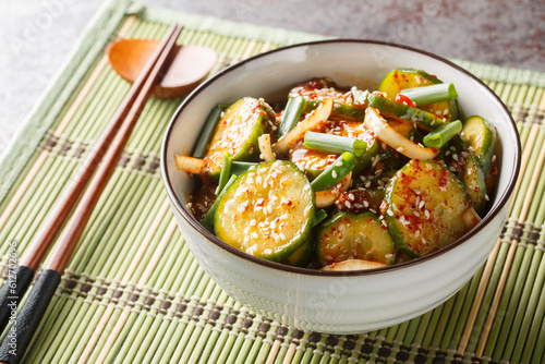 Easy Spicy Korean Cucumber Salad Oi Muchim made with garlic, onion, sesame and hot peppers on the table. Horizontal photo