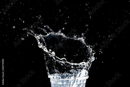 water splash in a glass. water splash isolated on black.