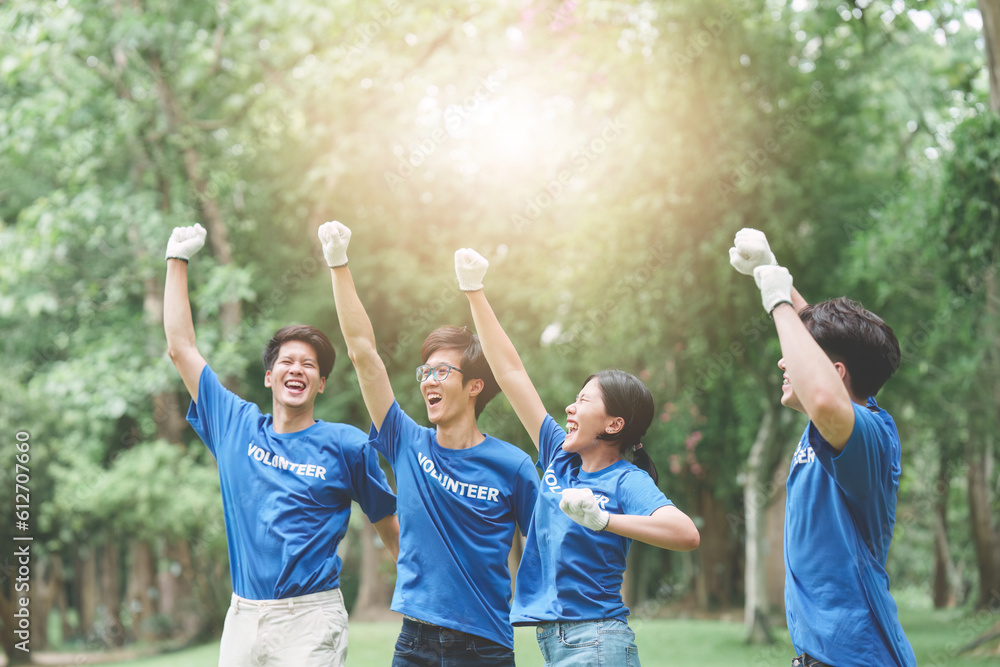 Young Asian Volunteers happy and celebrate at park area. Ecology, Charitable organization concept Young Asian Volunteers happy and celebrate at park area. Ecology, Charitable organization concept