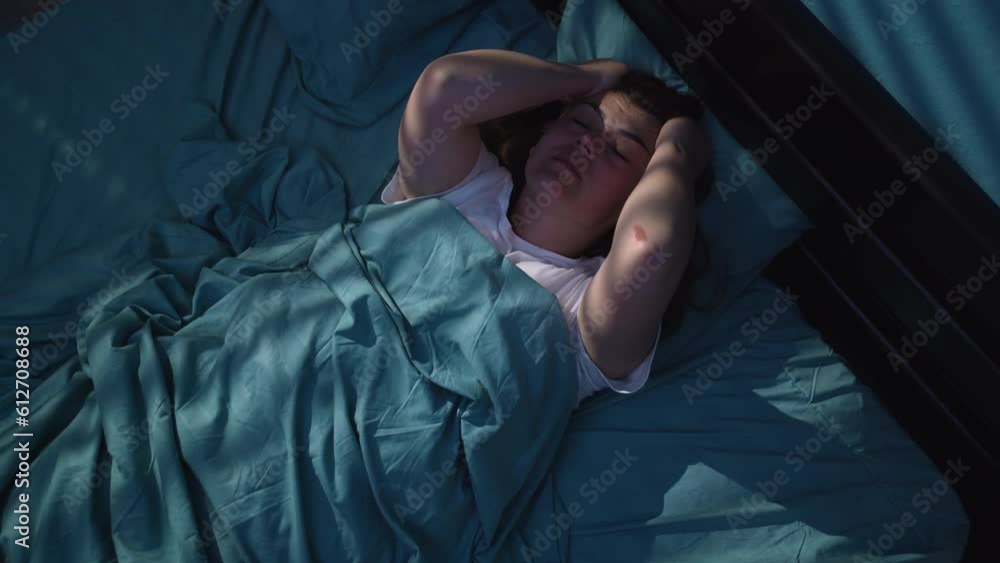 Sleepless woman suffering from insomnia. Tired and exhausted woman. Headache or migraine. Awake in the middle of the night. Sleepless woman suffering from insomnia. Tired and exhausted woman. Headache or migraine. Awake in the middle of the night.