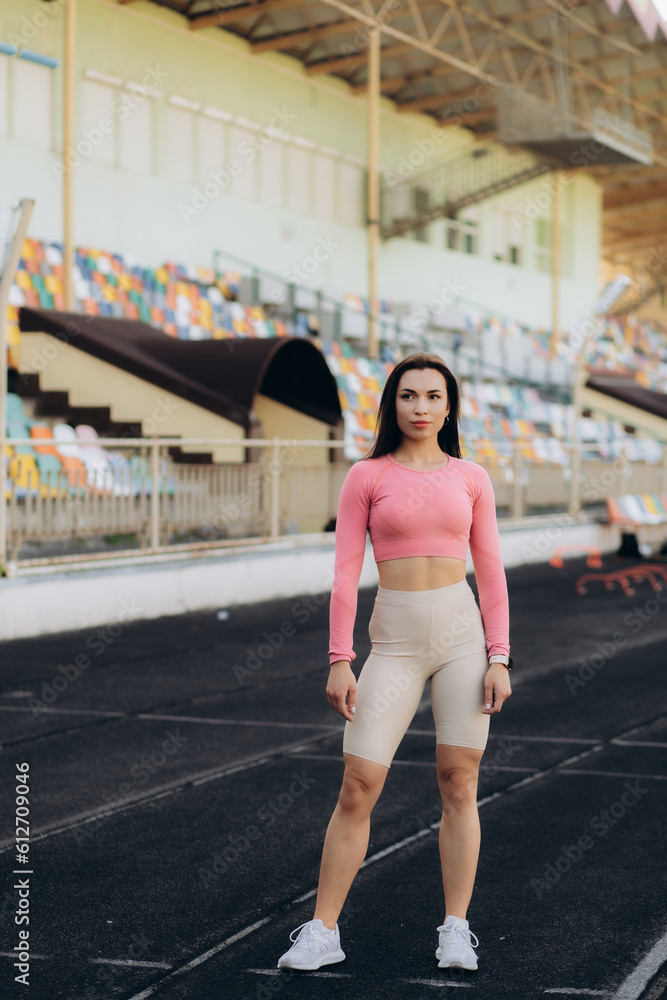 Woman portrait, athlete and fitness in an outdoor stadium happy about exercise, training and run. Black woman sports runner with a smile with happiness of health workout and sport goals outdoor.