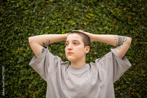 Portrait of Latin transgender generation z person with the short hair looking away.  © Creative Sparks