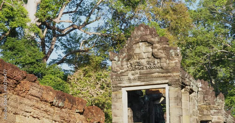 Ruins of Preah Khan temple in Angkor complex, overgrown by trees, Cambodia Ruins of Preah Khan temple in Angkor complex, overgrown by trees, Cambodia