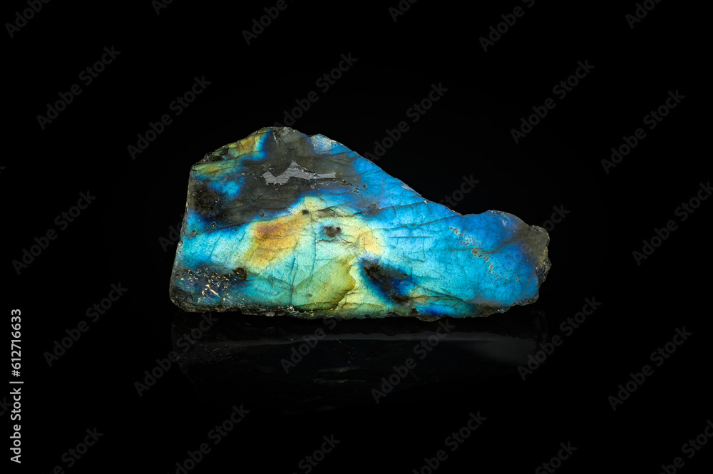 blue labradorite isolated on black background. macro detail texture. close-up polished semi-precious gemstone. blue labradorite isolated on black background. macro detail texture. close-up polished semi-precious gemstone.