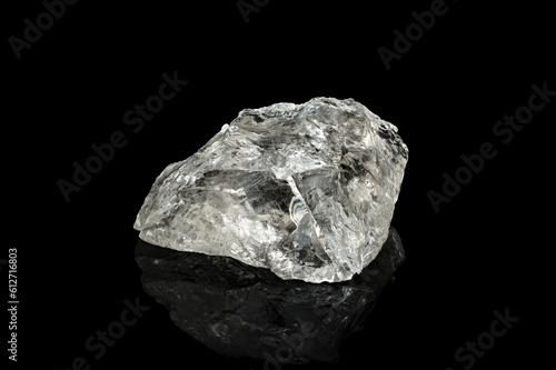 clear quartz isolated on black background. macro detail close-up rough raw unpolished semi-precious gemstone.