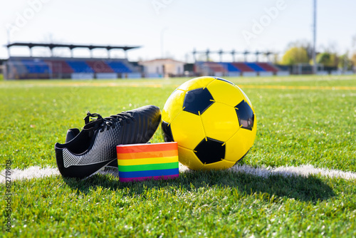 Rainbow colors of gay pride for fight for rights of LGBTQ people collective in soccer. Homosexuality and transsexuality in sport. Football equipment with captain's armband of the pride flag. photo