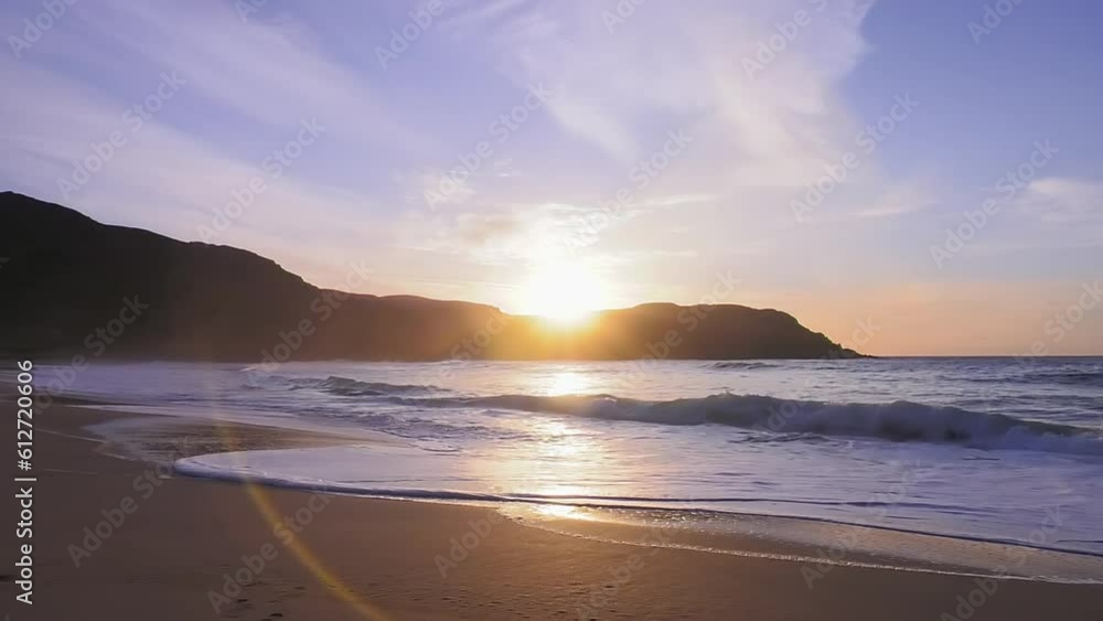 Golden hour shot of the sun setting over Dail Beag beach. Shot in the evening on the Isle of Lewis, part of the Outer Hebrides of Scotland. Golden hour shot of the sun setting over Dail Beag beach. Shot in the evening on the Isle of Lewis, part of the Outer Hebrides of Scotland.