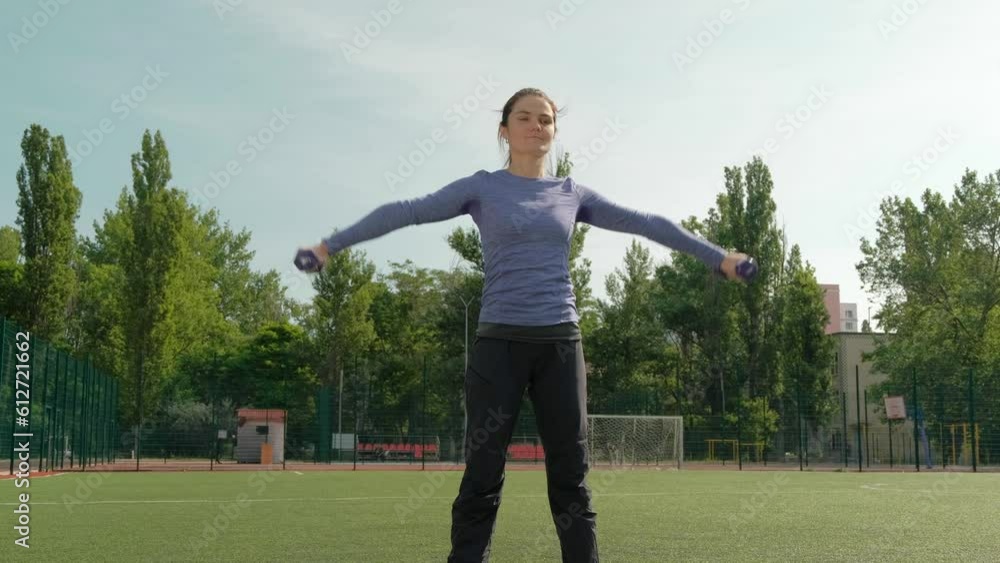 Young Woman Lifting Dumbbells For Training Young Woman Lifting Dumbbells For Training