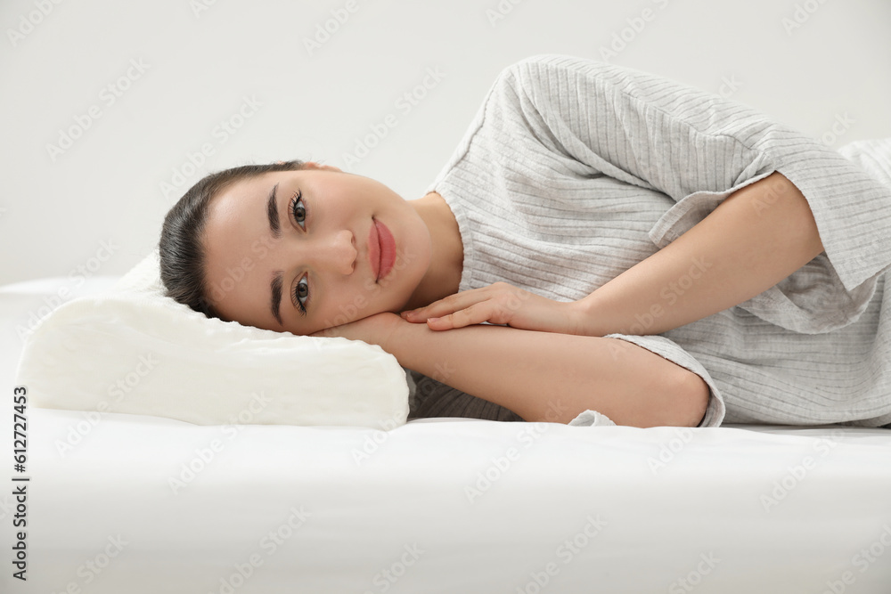 Woman lying on orthopedic memory foam pillow indoors Woman lying on orthopedic memory foam pillow indoors