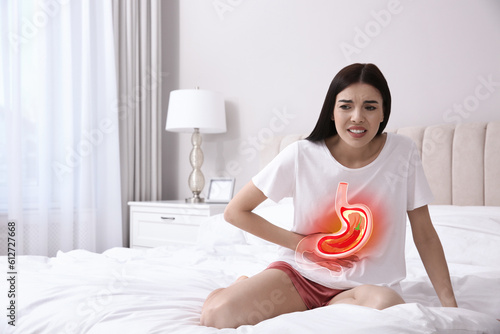 Woman suffering from heartburn at home. Stomach with hot chili pepper symbolizing acid indigestion, illustration photo