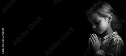 Black and white studio portrait of a young child praying banner on black background. Generative AI illustration