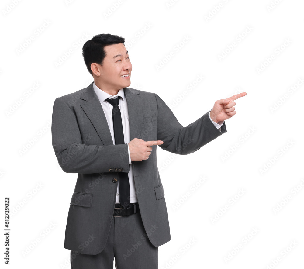 Businessman in suit pointing at something on white background Businessman in suit pointing at something on white background