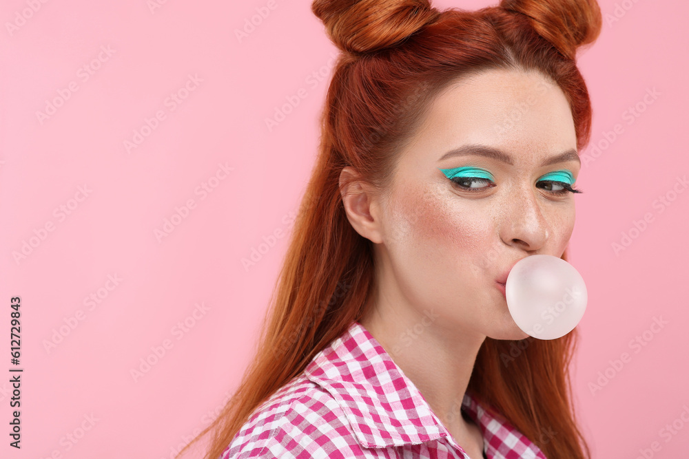 Beautiful woman with bright makeup blowing bubble gum on pink background. Space for text Beautiful woman with bright makeup blowing bubble gum on pink background. Space for text