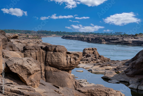 Stone scenery that is eroded by river. When water level of Mekong river down, beautiful shape of stones can be found. Taken at Sam Phan Bok, Ubon Ratchathani, Thailand. Shape stone face dog