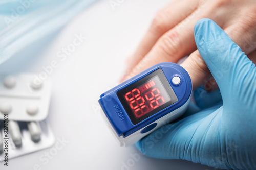 Pulse oximeter measuring oxygen saturation in blood and heart rate photo
