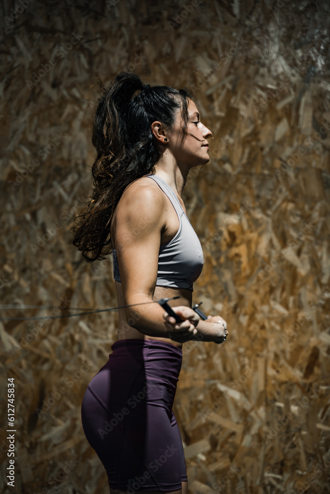 woman jumping rope at crossfit gymnasium