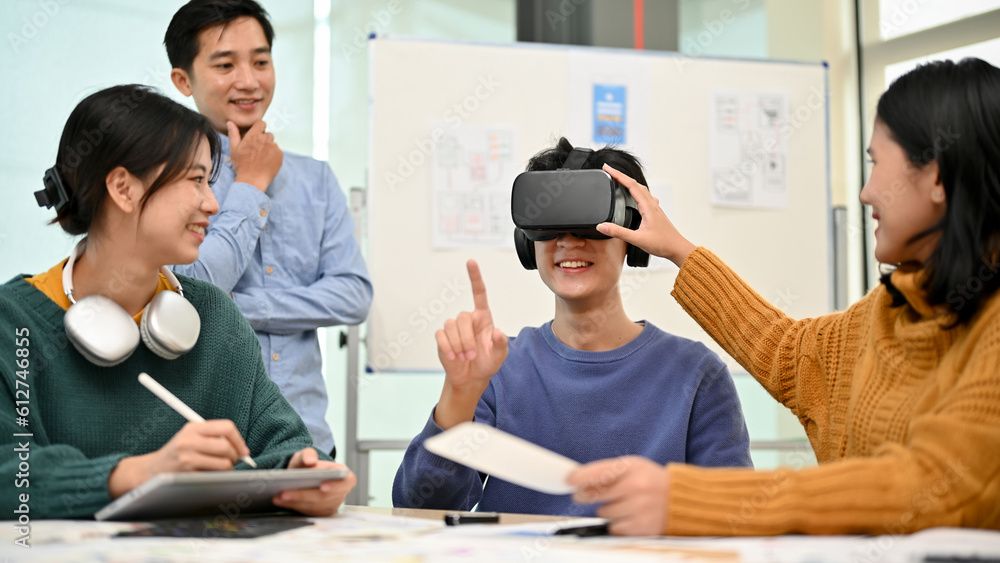 A team of Asian developers is in the meeting and excited about their newly developed VR game A team of Asian developers is in the meeting and excited about their newly developed VR game