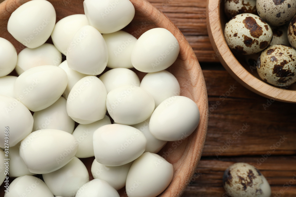 Unpeeled and peeled boiled quail eggs on wooden table, flat lay Unpeeled and peeled boiled quail eggs on wooden table, flat lay