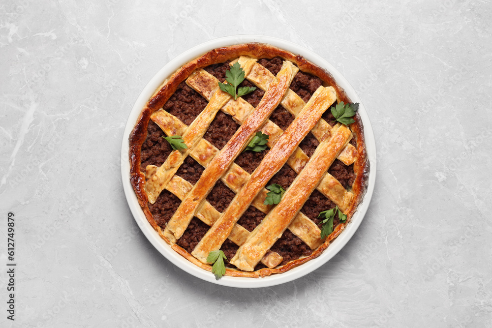 Freshly baked meat pie on light grey table, top view Freshly baked meat pie on light grey table, top view